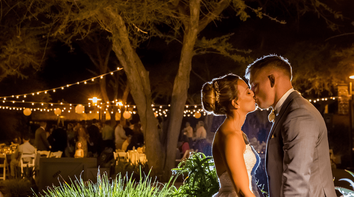 A wedding at the Safari Park, bride and groom kissing.