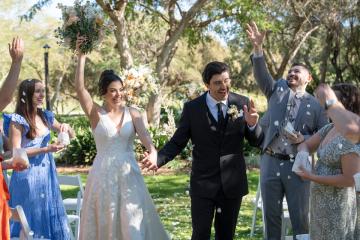 Couple walking down aisle at Haruis Lawn
